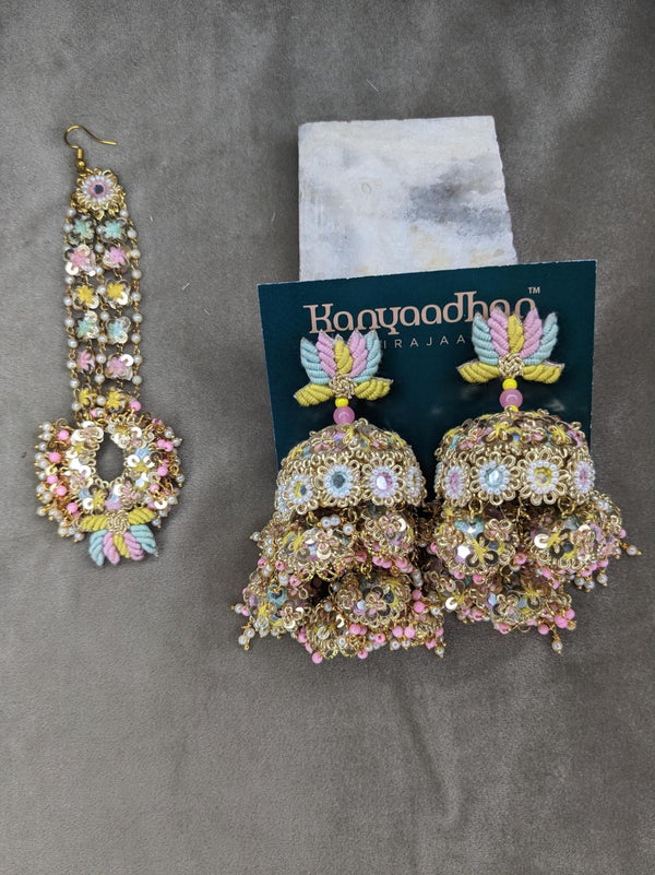 Exquisite Earrings Adorned with Multicolored Gemstones, Complemented by a Matching Maang Tikka with Delicate Floral Accents.