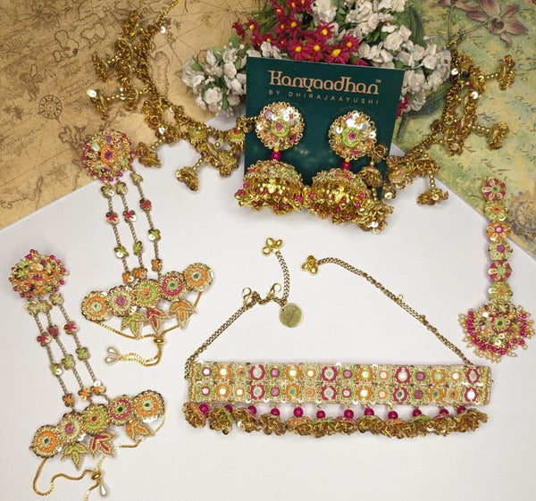 Dazzling Set FeaturingEarrings with Ear Chains, Intricately Designed Maang Tikka, and an Embellished Necklaces, shop-by-style, shop-by-vibe, All Bedecked with Vibrant Gemstones and Delicate Floral Motifs.