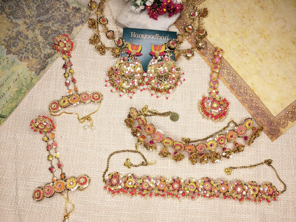 Dazzling Jewelry Set Comprising of Earrings, Necklaces, shop-by-style, shop-by-vibe, and Bracelets, All Embellished with Vibrant Gemstones and Intricate Floral Motifs.